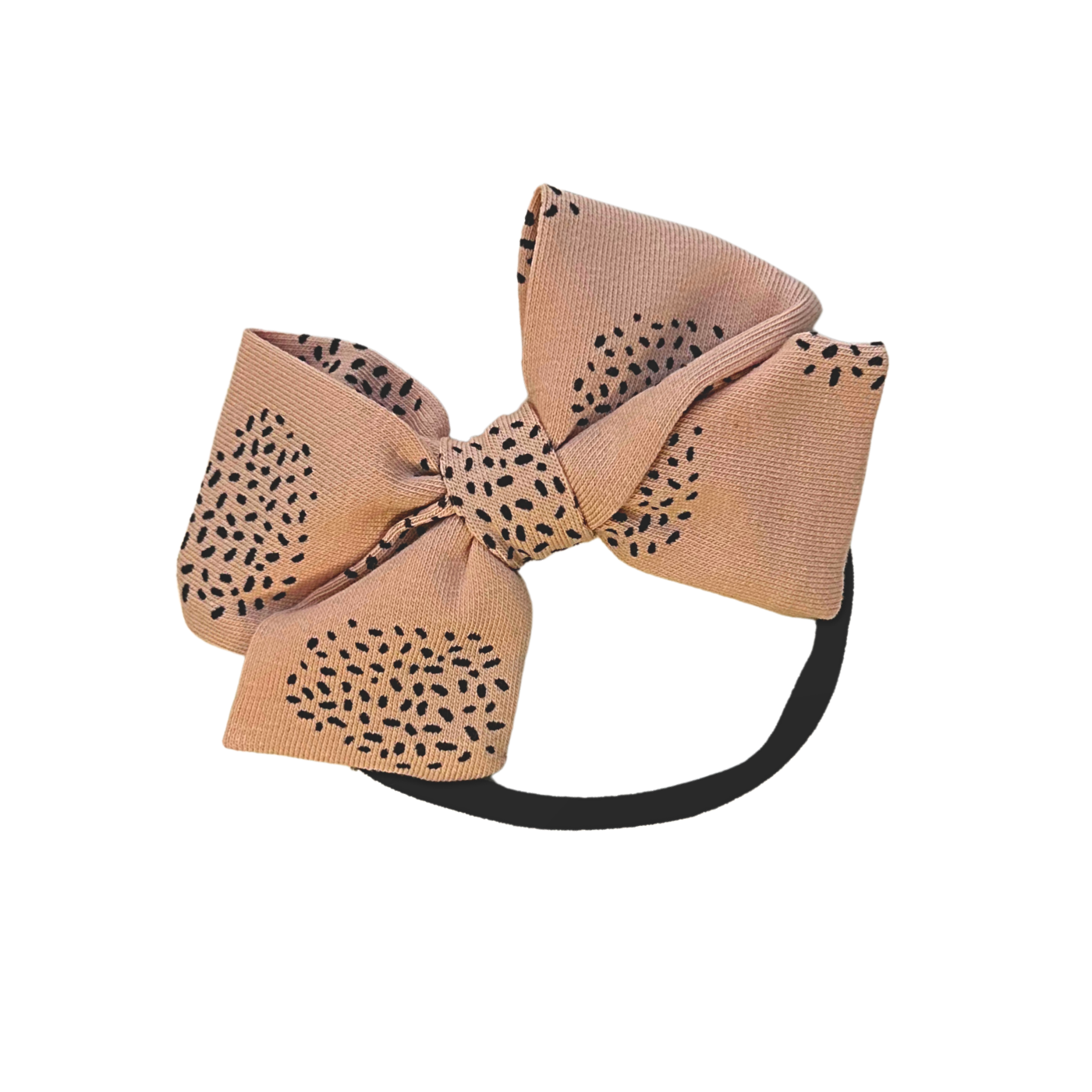 Large blush pink bow hair headband with black dot pattern on a pink background